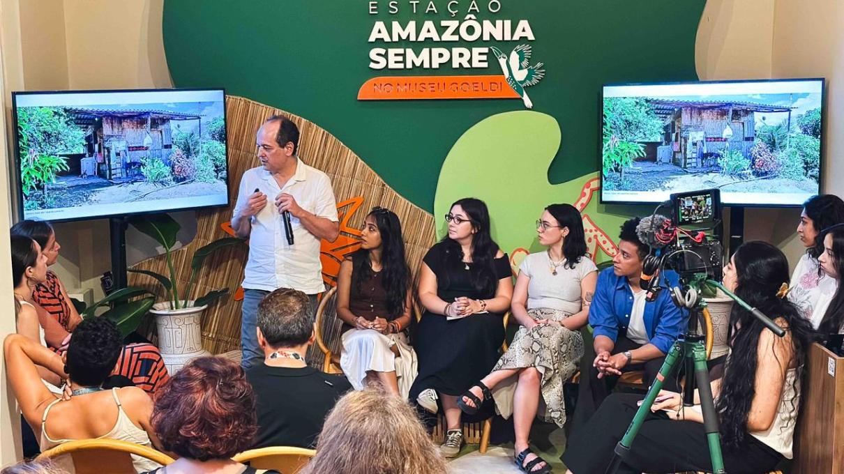 A group of students sit in a circle listening to a presenter at COP30.