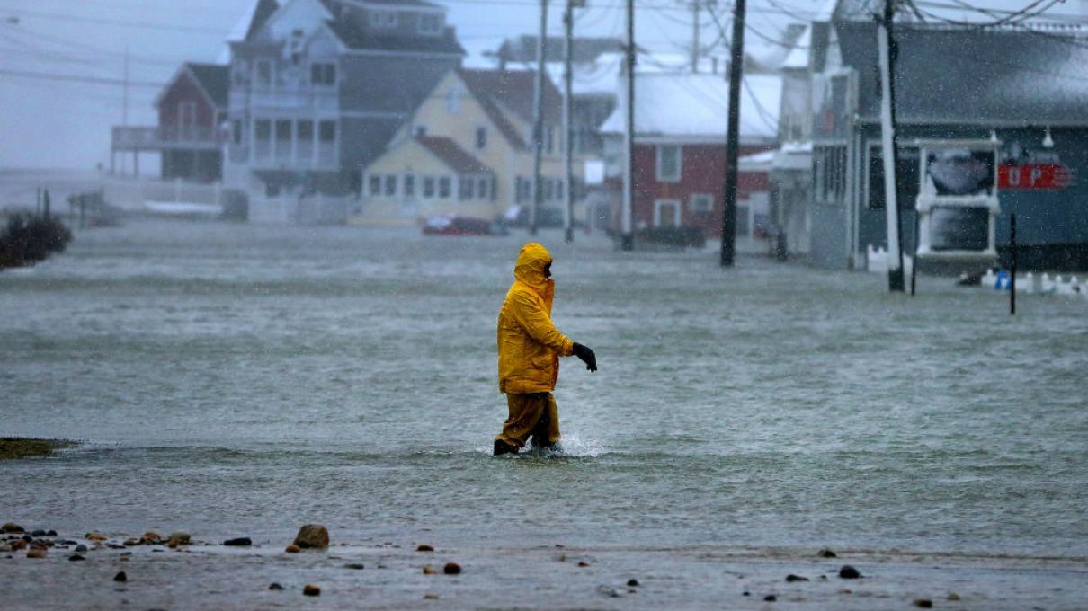 MARSHFIELD, MA - JANUARY 4: A man walks through a flooded section of Brant Rock in Marshfield, Mass., on Jan. 4, 2018, as the afternoon high tide struck during the blizzard. (Photo by John Tlumacki/The Boston Globe via Getty Images)